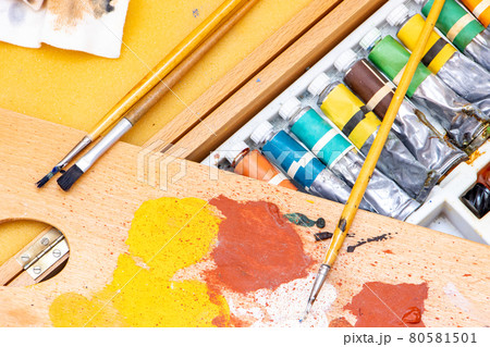 Set of oil paints with brushes on palette, close up. Set of oil paints with brushes on palette, close up. 80581501