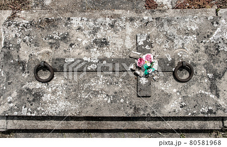 The tombstone with a cross on a cemetery. The tombstone with a cross on a cemetery. 80581968