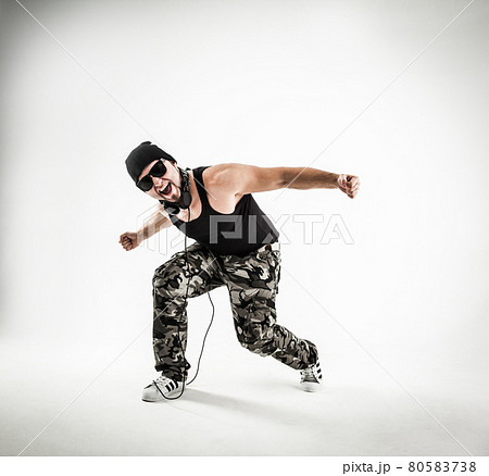 energetic and charismatic guy rapper dances break dance. 80583738