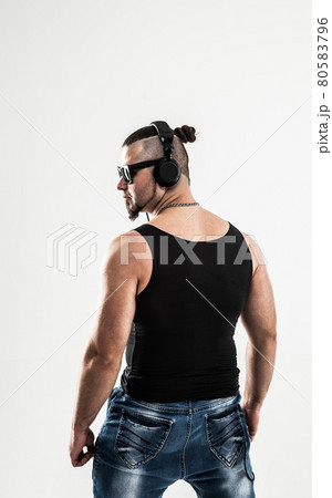 rear view - bodybuilder with headphones and sunglasses rear view - bodybuilder with headphones and sunglasses 80583796