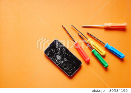 Top view of broken smart phone on color background  80584196