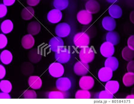 blurred image of purple lights on a black background 80584375