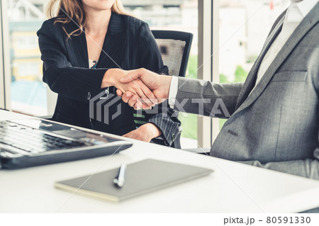 Businessman handshake businesswoman in office. 80591330