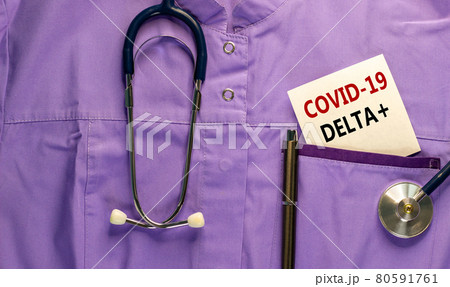 Covid-19 delta plus variant symbol. Medical uniform, white card with words Covid-19 delta plus, metalic pen and stethoscope. Medical and Covid-19 delta plus strain virus concept. 80591761