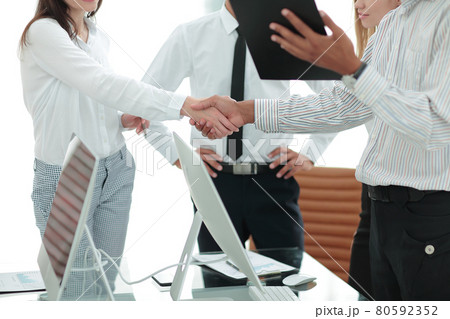 strong handshake between man and woman, both sides viewpoints and interests have been considered. 80592352