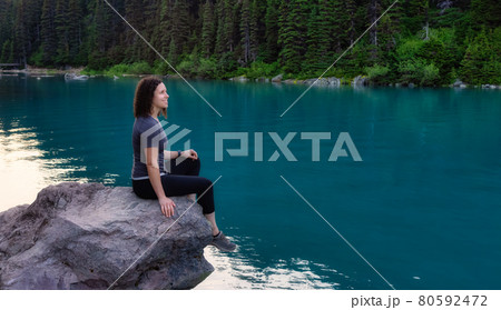 Adventurous White Caucasin Adult Woman Hiking on a trail in Canadian Nature Adventurous White Caucasin Adult Woman Hiking on a trail in Canadian Nature 80592472