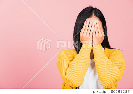 young woman in depressed bad mood her cry close face by hands young woman in depressed bad mood her cry close face by hands 80595287