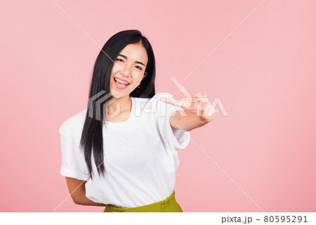 woman teen smile standing showing finger making v-sign victory symbol woman teen smile standing showing finger making v-sign victory symbol 80595291