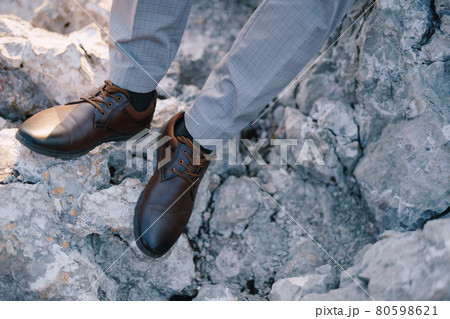 Groom feet in shoes on a rock. Close-up 80598621