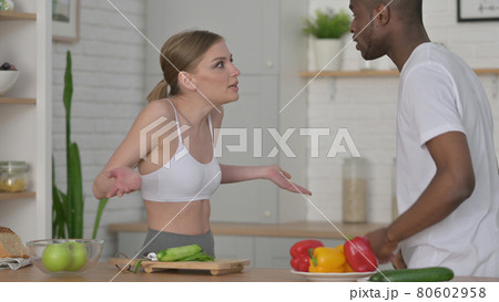 Fighting Woman Arguing with African Man in Kitchen Fighting Woman Arguing with African Man in Kitchen 80602958