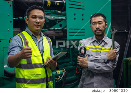 Engineer at work in a Power Plant industrial factory, holding a wrench in his hand. Engineer at work in a Power Plant industrial factory, holding a wrench in his hand. 80604030