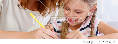 Blond little girl hold in arm pencil drawing something Blond little girl hold in arm pencil drawing something 80604617