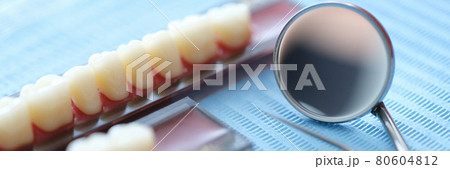 Set of dentures and dental instruments. closeup Set of dentures and dental instruments. closeup 80604812