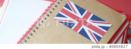 Stylish notepad with britain flag and copybooks on table Stylish notepad with britain flag and copybooks on table 80604827