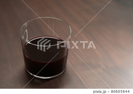 Red wine in tumbler glass on a walnut table with copy space Red wine in tumbler glass on a walnut table with copy space 80605644