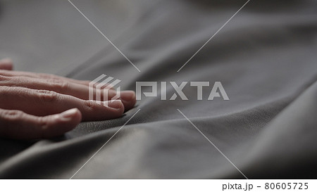 Closeup man touching fine leather 80605725