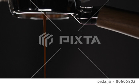side view of pulling espresso shot with naked portafilter side view of pulling espresso shot with naked portafilter 80605802