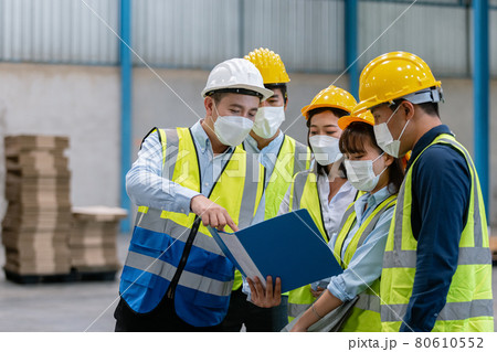 Team engineer in uniform wear protection mask brainstorming workshop industrial factory building. Team engineer in uniform wear protection mask brainstorming workshop industrial factory building. 80610552