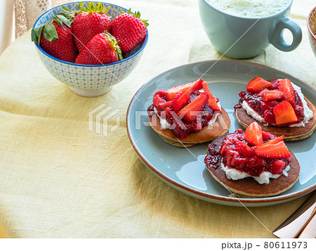 Vegan buckwheat gluten free pancakes breakfast served with chia strawberry jam and dairy free yogurt 80611973
