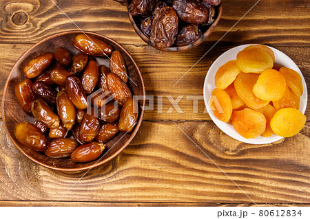 Dried apricots and dates fruit on wooden table. Top view 80612834