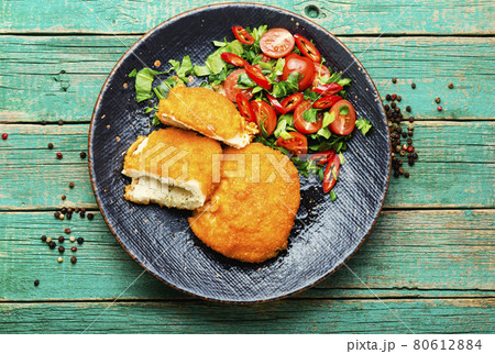 Chicken kiev cutlet with salad Chicken kiev cutlet with salad 80612884