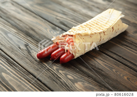 homemade sausages in pita bread on wooden background.photo with 80616028