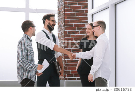 handshake business colleagues in the office lobby. 80616758
