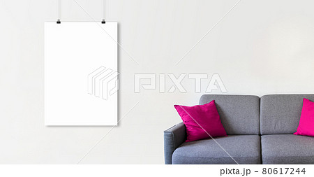 Blank hanging poster on a white wall above a sofa. Horizontal banner 80617244