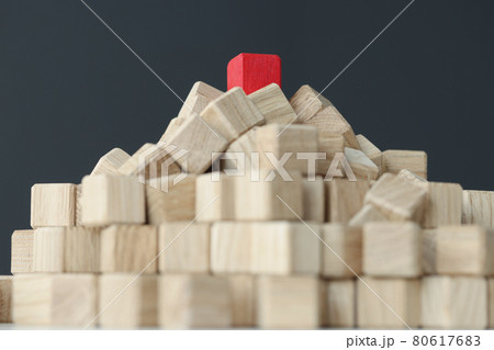 Pyramid of beige cubes on top with single red one on table Pyramid of beige cubes on top with single red one on table 80617683