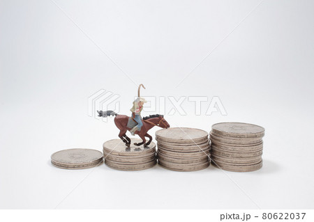a Mini men riding horse on coin stacks. a Mini men riding horse on coin stacks. 80622037