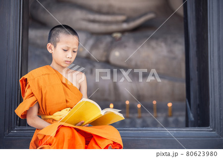 Young novice monk reading a book in Wat Phutthai Sawan Temple, Ayutthaya 80623980