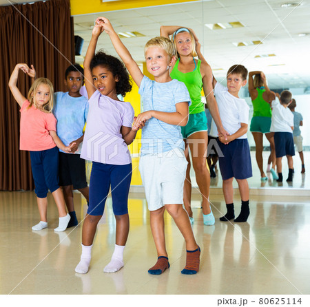 Positive little boys and girls dancing pair dance in the ballet studio 80625114
