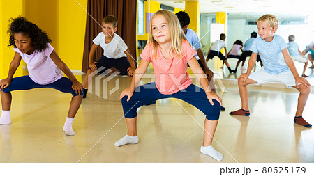 Portrait of smiling children practicing sport dance in modern dance hall 80625179