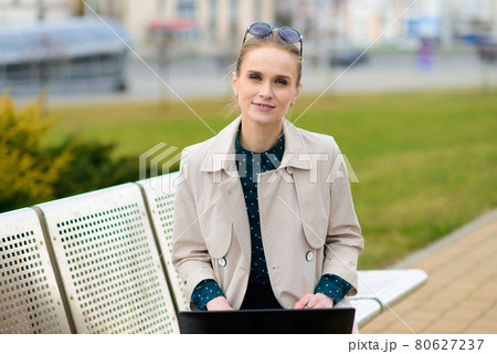 Young beautiful businesswoman with sunglasses, phone in the city streets. Young beautiful businesswoman with sunglasses, phone in the city streets. 80627237