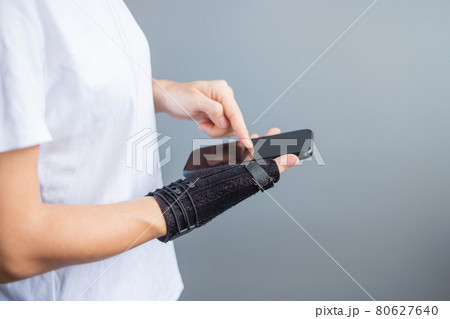 woman holding her wrist pain because using smartphone long time. De Quervain's tenosynovitis, Intersection Symptom, Carpal Tunnel Syndrome or Office syndrome concept 80627640