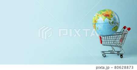 World sale and Internet sales concept. Supermarket cart with earth globe on blue background. World trade and delivery of purchases World sale and Internet sales concept. Supermarket cart with earth globe on blue background. World trade and delivery of purchases 80628873
