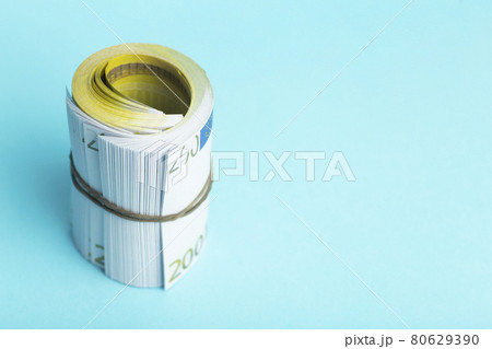 Money and income concept. Euro cash banknotes on a blue background. Saving and spending money Money and income concept. Euro cash banknotes on a blue background. Saving and spending money 80629390