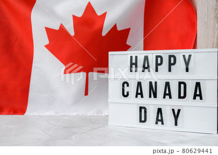 The National Flag of Canada. Lightbox with text HAPPY CANADA DAY Canadian Flag or the Maple Leaf. Patriotism. International relations concept. Independence day The National Flag of Canada. Lightbox with text HAPPY CANADA DAY Canadian Flag or the Maple Leaf. Patriotism. International relations concept. Independence day 80629441