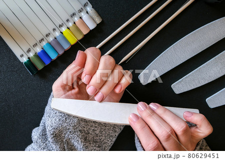 Work at home with nails. Nail care, Self care. Female manicure. Do manicure by yourself while staying at home. Female hands and manicure tools 80629451