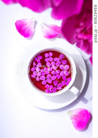 Creative layout with pink peonies flowers and cup of tea on bright table. Spring Seasonal valentine, woman, mother, 8 march holiday, romance breakfast. Stylish blogger. Greeting card 80629468