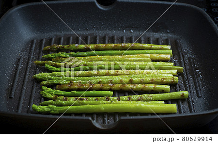 Grilled asparagus. Fried asparagus in a pan. Grilled vegetables on the barbecue. Veg concept 80629914