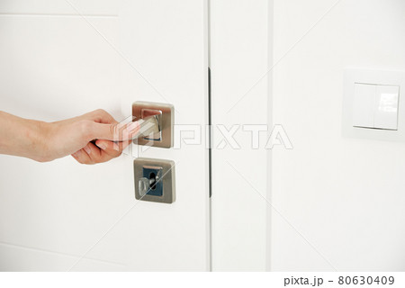 Woman open door and entrance in the room 80630409