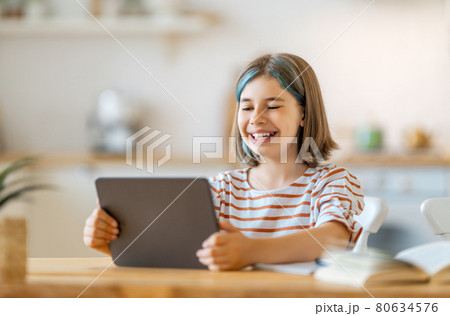 Girl doing homework or online education. 80634576