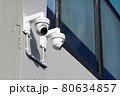 CCTV surveillance camera installed on concrete wall outside the building 80634857