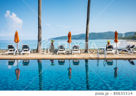 Empty beach deck chair reflecting in swimming pool 80635514