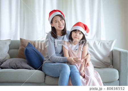 Asian Mother Daughter enjoy to celebrate Christmas and new year party at home Asian Mother Daughter enjoy to celebrate Christmas and new year party at home 80636552