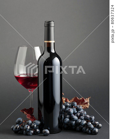Red wine and grapes with dried-up vine leaves. Red wine and grapes with dried-up vine leaves. 80637324