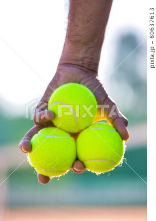 Photo of senior man holding tennis balls on court Photo of senior man holding tennis balls on court 80637613