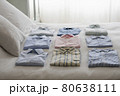 Variety Of Shirts On Bed 80638111