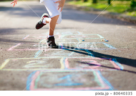 Kids play hopscotch in summer park. Outdoor game. Kids play hopscotch in summer park. Outdoor game. 80640335